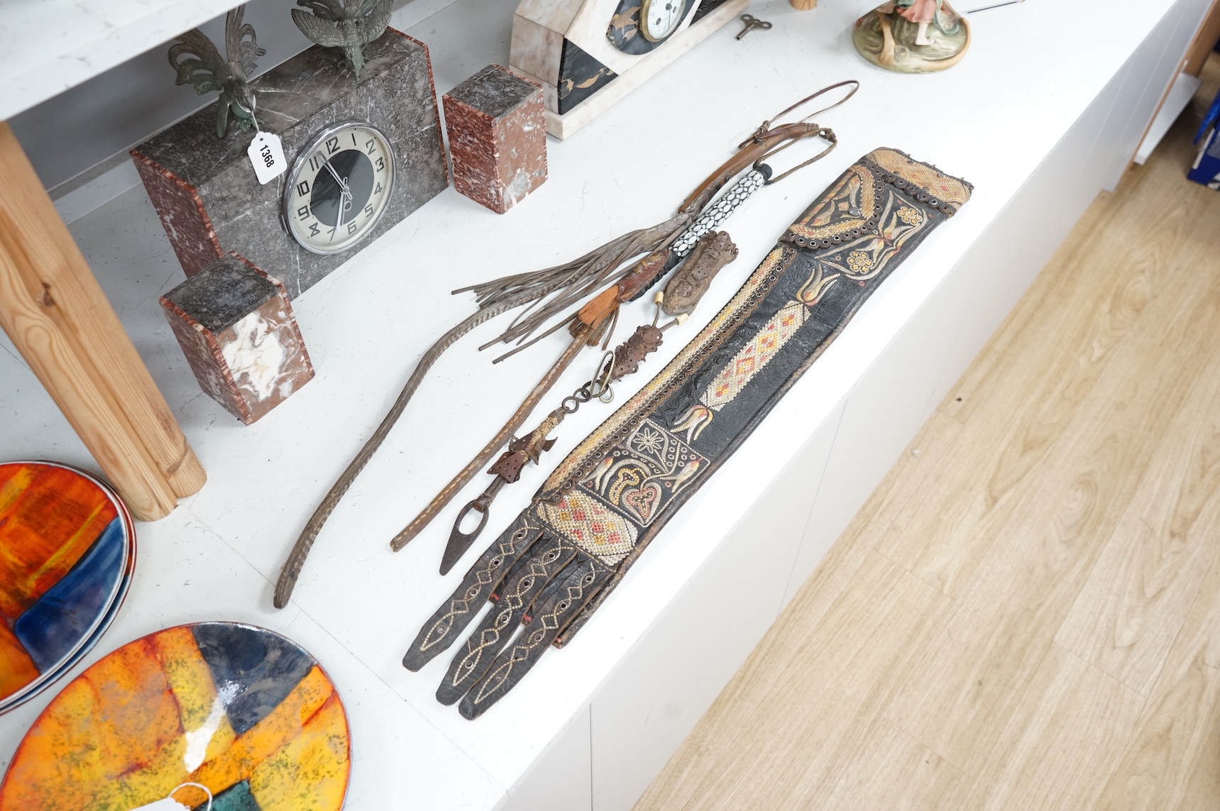 An Argentinian braided leather belt and whips, one with mother of pearl inlay